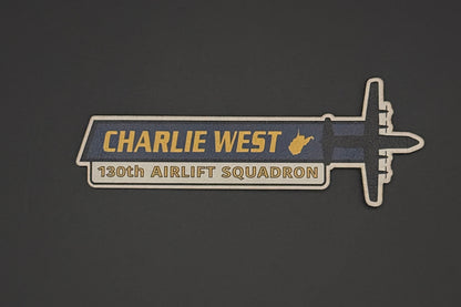 Pin with 'Charlie West' and '130th Airlift Squadron' text on a dark background